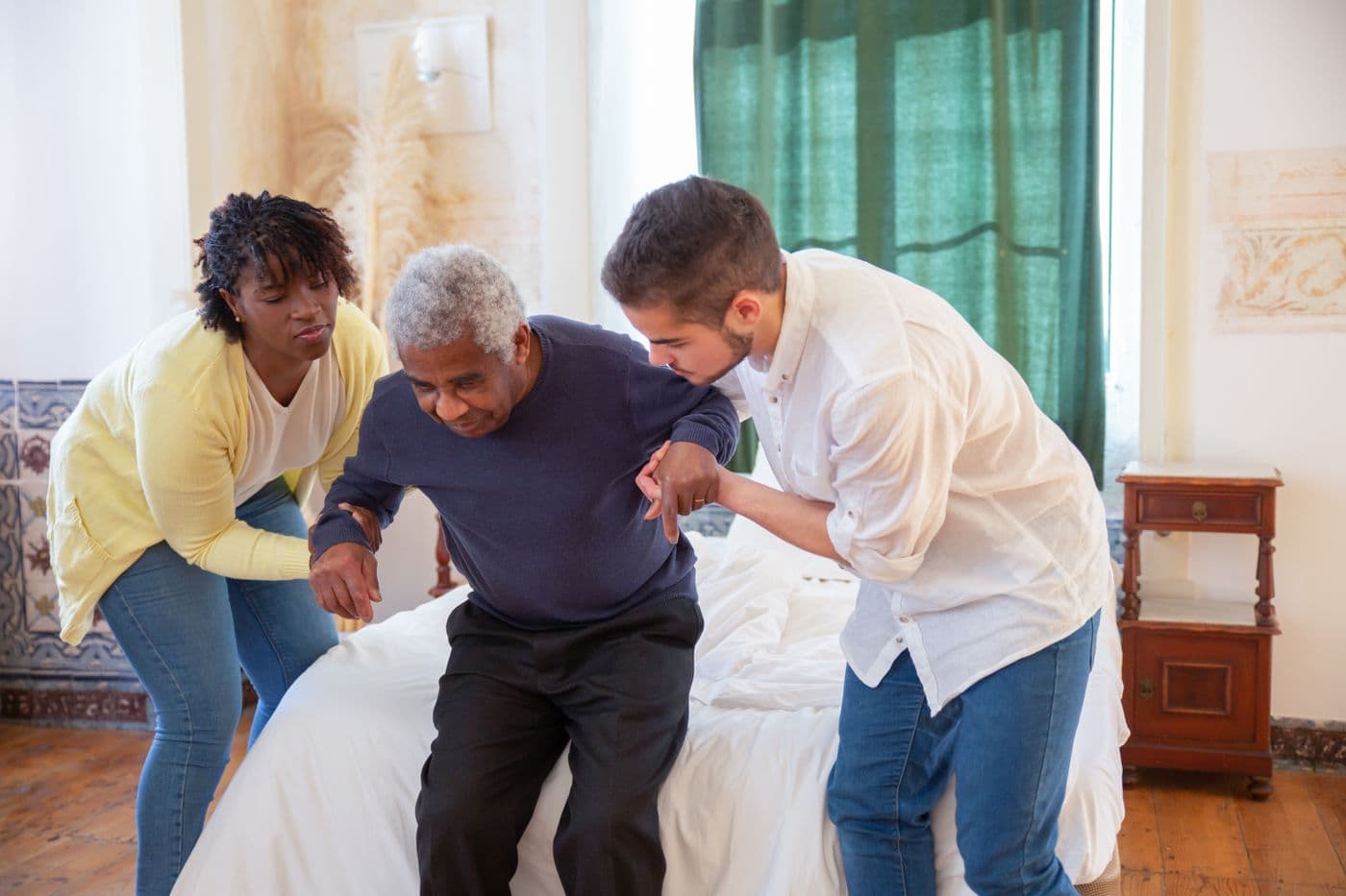 A family member helping an elderly relative at home
